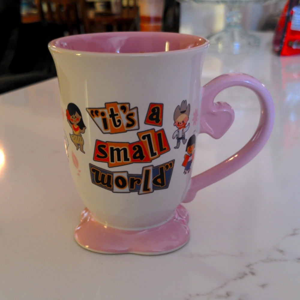 Disney Ride "It's a Small World" white and pink footed pedestal mug